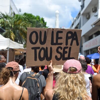 Une manifestante tient une pancarte sur laquelle on peut lire 