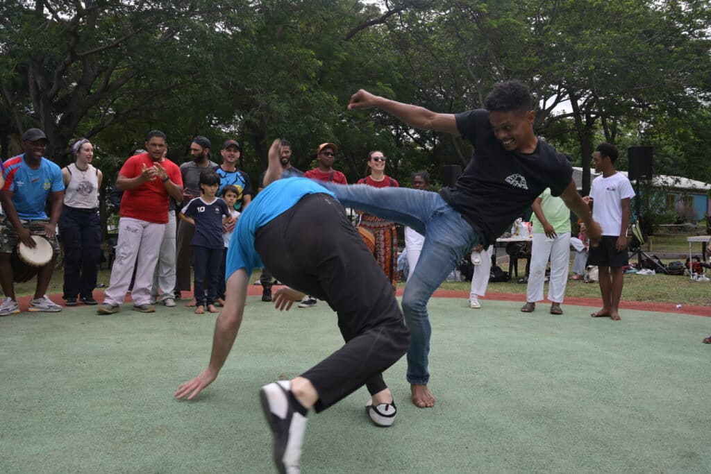 Démonstration de capoeira. Le moringueur (à droite) utilise plus ses pieds que son adversaire venant de la capoeira (à gauche).