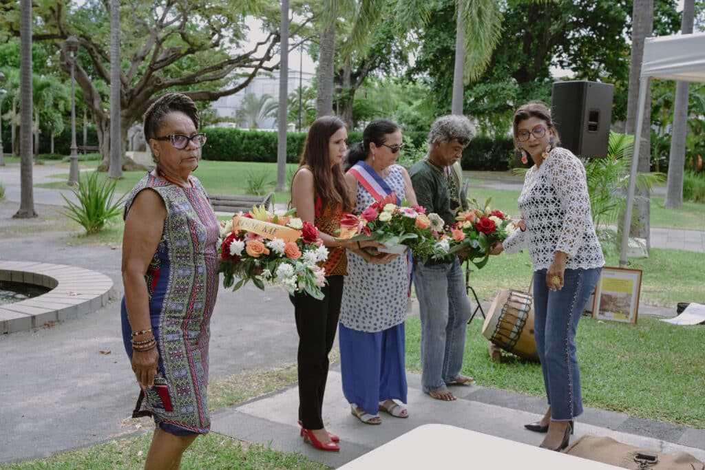 Ghislaine Bessière (1ère à gauche), Karine Lebon (2e gauche), Suzelle Bouchet (3e gauche) et Yvrin Rosalie se recueillent devant la statue d'Eli et ses frères. Une minute de silence sera observée.
