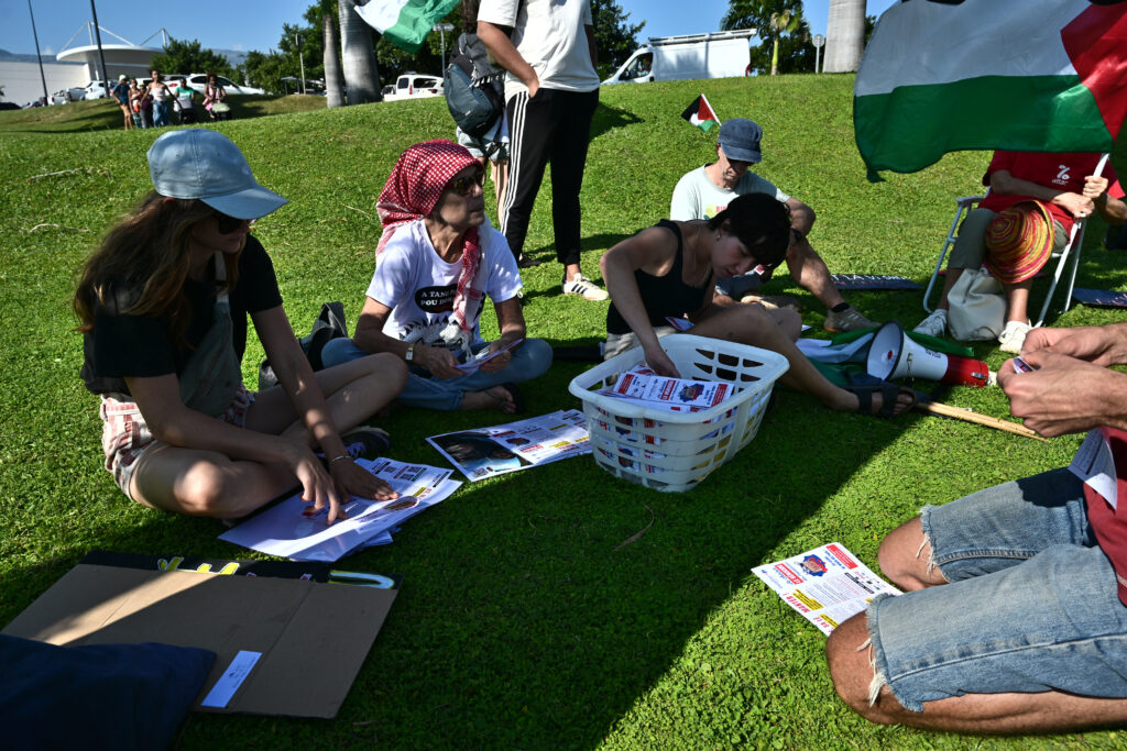 Les militant.es présent.es se préparent avant d'aller tracter au niveau du rond-point principal de la ZAC Canabady. © Olivier Ceccaldi