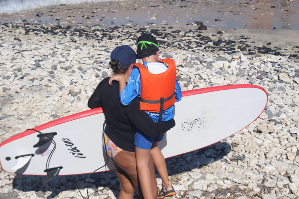 Mise à l'eau d'un jeune avec une bénévole.